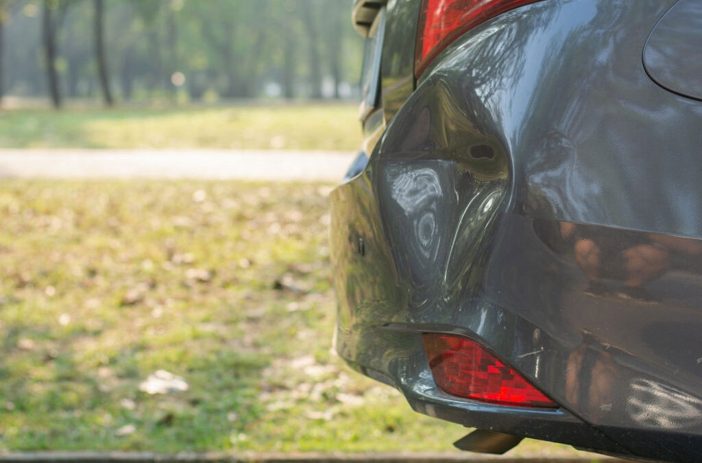 Dark grey car, dent